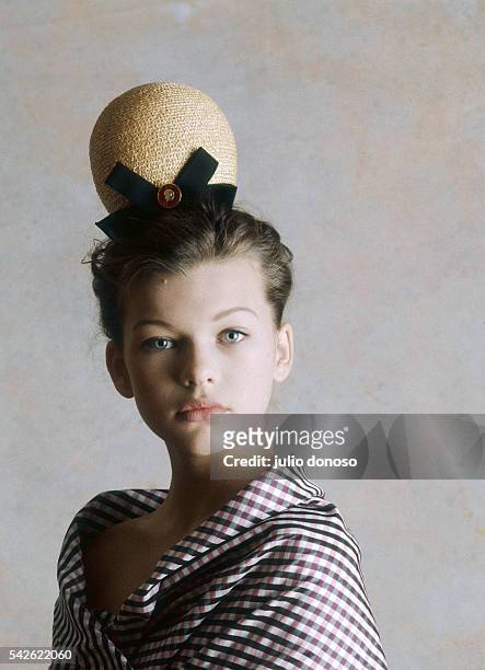 Young actress and fashion model Milla Jovovich at the age of twelve wearing a plaid shirt and hat by French designer Christian Lacroix. Jovovich...