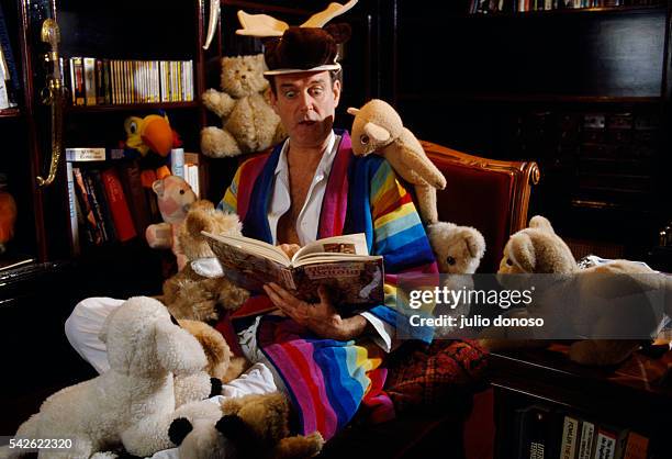 Comedic actor John Cleese reads a storybook to his stuffed animal friends.