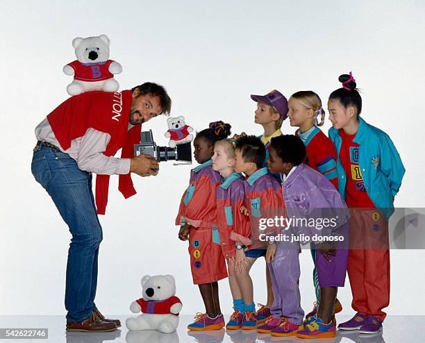 Italian photographer Oliviero Toscani photographs a group of children who are wearing Benetton clothing. Toscani began his collaboration with the...