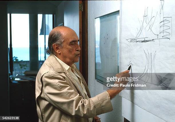Architect Oscar Niemeyer sketches in his studio in Copacabana, Rio de Janeiro, Brazil.