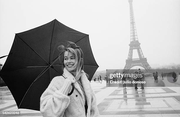 German top model Claudia Schiffer holds an umbrella at the Trocadero, near the Eiffel Tower, on a rainy day in Paris.