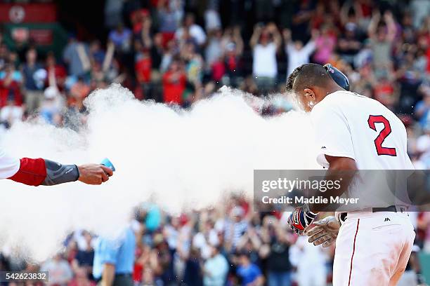 Clay Buchholz of the Boston Red Sox throws powder at Xander Bogaerts after he hit the game winning single during the tenth inning to defeat the...