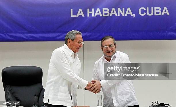 Cuban President Raul Castro and FARC's leader Timoleon Jimenez "Timonchenko"shake hands during a ceremony to sign a historic ceasefire agreement...