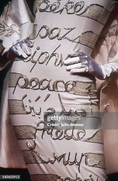 Italian designer Valentino shows his 1991 women's spring-summer haute couture line. The model is wearing a dress decorated with the word "peace" in...