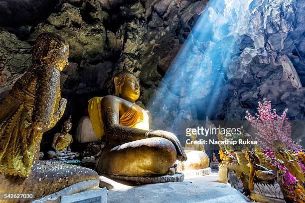 amazing buddhism with the ray of light in the cave - dambulla stock pictures, royalty-free photos & images