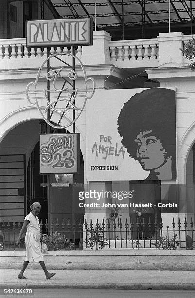Street scene of large billboard supporting American political activist Angela Davis, leader of Communist Party USA and author jailed in the US for...