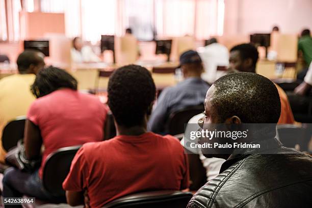 Refugees wait to fill in aplications for jobs at People wait on line to get service for jobs and unemployement insurance at CAT Centro de Apoio ao...