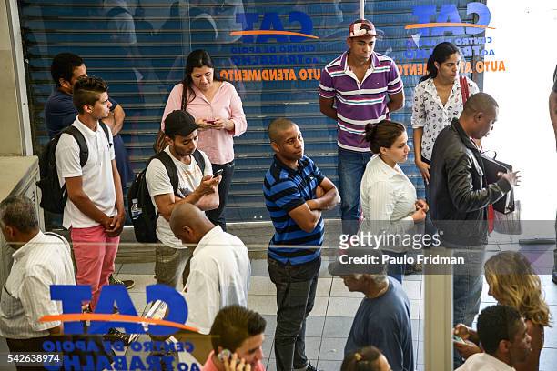 People wait in line to be served at CCAT Centro de Apoio ao Trabalho, Sao Paulo, Brazil on August 31st, 2015