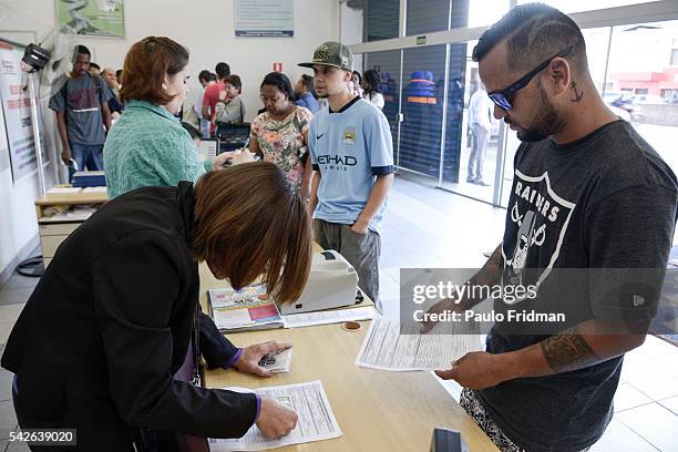 People wait in line to be served at CCAT Centro de Apoio ao Trabalho, Sao Paulo, Brazil on August 31st, 2015