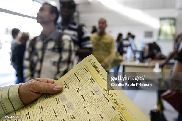 Man reads the paper looking for jobs at the line of the CAT Centro de Apoio ao Trabalho, Sao Paulo, Brazil on August 31st, 2015
