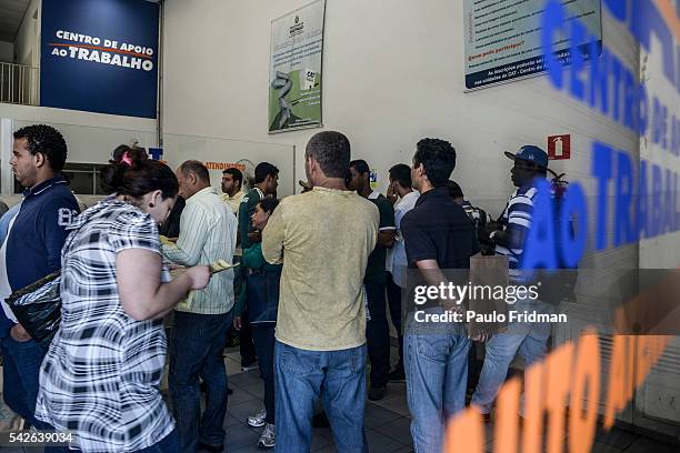 People wait in line to be served at CCAT Centro de Apoio ao Trabalho, Sao Paulo, Brazil on August 31st, 2015