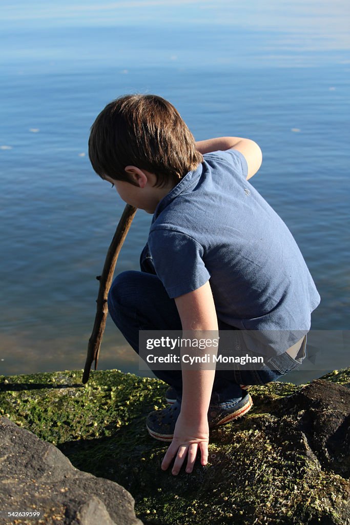 Boy playing next to water