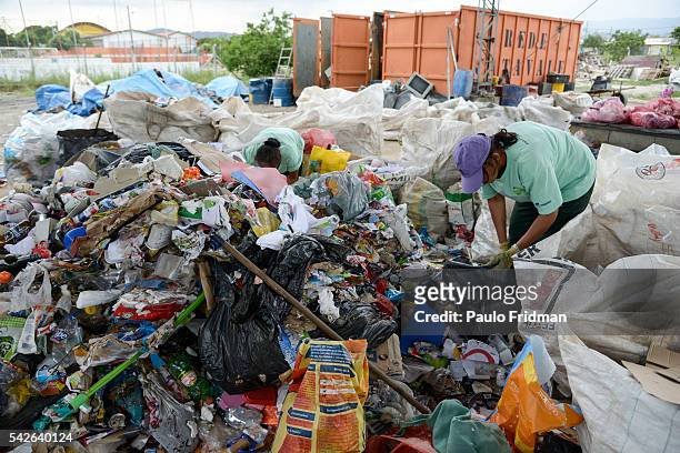 Workers separate trash from aluminium for recycling at Cooperativa de Trabalho Moreira Recicla in Pindamonhangaba, Brazil, on Wednesday, Nov. 4,...