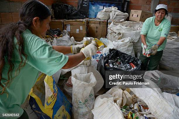 Workers separate trash from aluminium for recycling at Cooperativa de Trabalho Moreira Recicla in Pindamonhangaba, Brazil, on Wednesday, Nov. 4,...