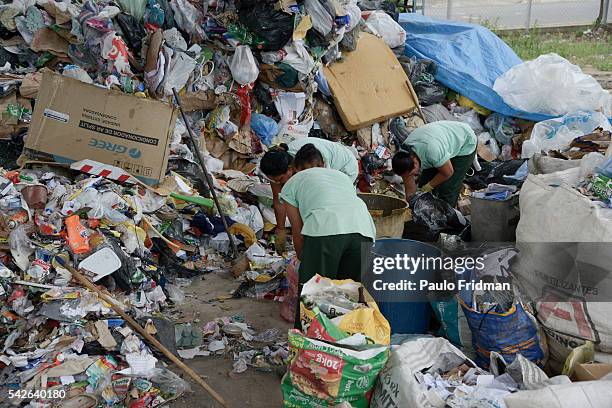 Workers separate trash from aluminium for recycling at Cooperativa de Trabalho Moreira Recicla in Pindamonhangaba, Brazil, on Wednesday, Nov. 4,...