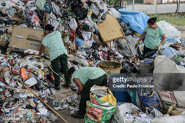 Workers separate trash from aluminium for recycling at Cooperativa de Trabalho Moreira Recicla in Pindamonhangaba, Brazil, on Wednesday, Nov. 4,...