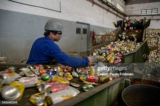 Worker inspects aluminum cans to be recycled at at Centro de Coleta – Latasa Reciclagem S.A., Pindamonhangaba, State of Sao Paulo, Brazil ,on...