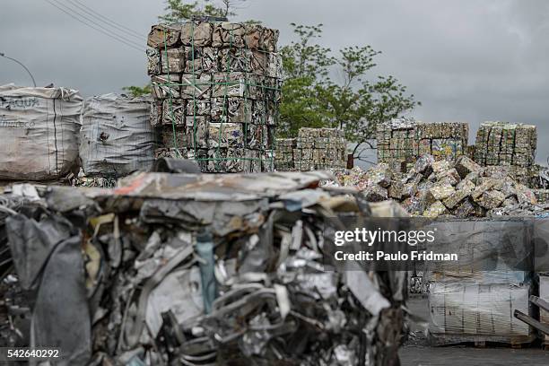 Bales of crushed aluminium cans sit outside a warehouse after being unloaded from a truck at the Latasa Reciclagem SA collection center in...