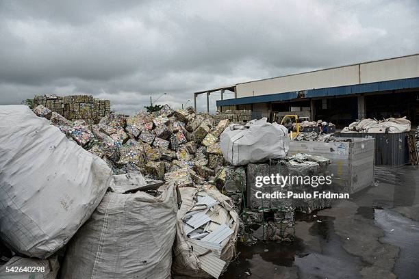Bales of crushed aluminium cans sit outside a warehouse after being unloaded from a truck at the Latasa Reciclagem SA collection center in...