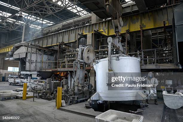 Worker uses a remote device to move a tank of liquified aluminium during the recycling process at the at the Latasa Reciclagem SA collection center...