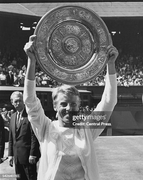 English tennis player Ann Jones holds the trophy after beating Billie Jean King of the USA in the final of the Ladies' Singles at the Wimbledon Lawn...