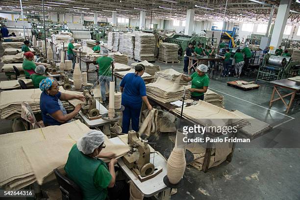 Workers sew jute to produce bags that are mainly used in the coffee that is exported at Brasjuta da Amazonia S.A , Industrial District , Manaus on...