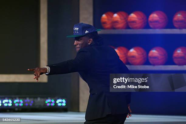 Taurean Prince walks ons stage after being drafted 12th overall by the Utah Jazz in the first round of the 2016 NBA Draft at the Barclays Center on...