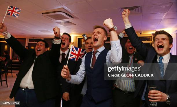 Leave.EU supporters wave Union flags and cheer as the results come in at the Leave.EU referendum party at Millbank Tower in central London early in...