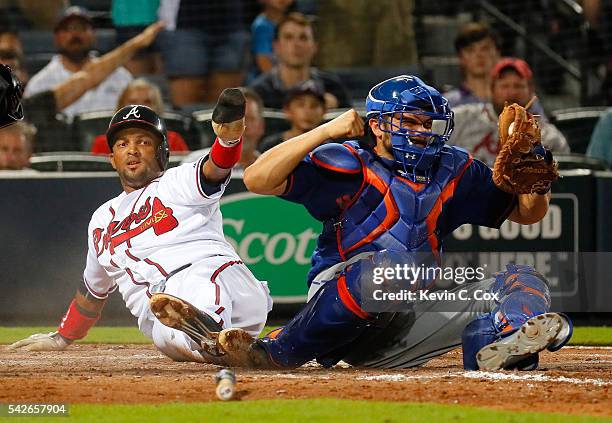 Travis d'Arnaud of the New York Mets reacts as homeplate umpire Jordan Baker calls out Emilio Bonifacio of the Atlanta Braves to end the seventh...