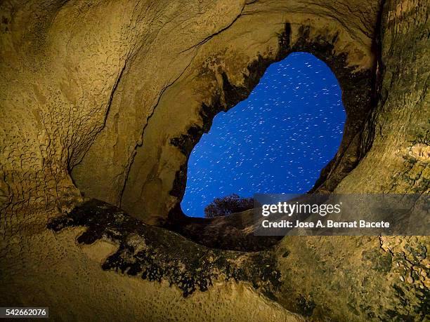 interior during the night  of the cave,  cueva horadada, " the perforated one " placed in the mount arabí. heritage of the humanity. unesco - arid woodlands stock-fotos und bilder