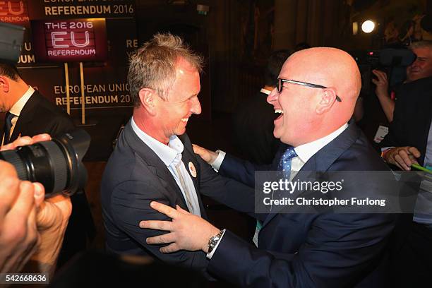Paul Nuttal MEP and Nigel Evans MP of Vote Leave celebrate as positive results come in from the counts before the official referendum announcement at...