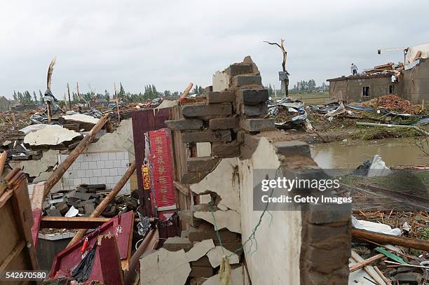 Collapsed houses are seen on June 24 Jiangsu Province of China. Heavy hail and a strong tornado has hit eastern China's Jiangsu province on June 23,...