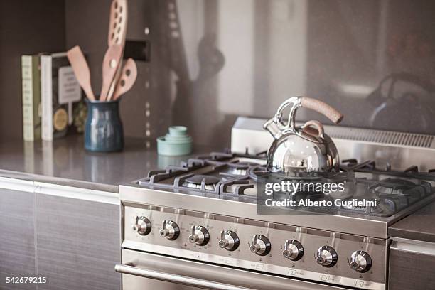 tea kettle on the stove - kettle stockfoto's en -beelden