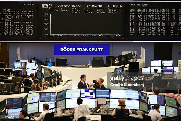 Financial traders monitor data before the DAX index is displayed inside Frankfurt Stock Exchange following the U.K's European Union referendum vote...