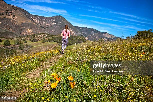 young girl hiking on a trail - girls in leggings stock-fotos und bilder