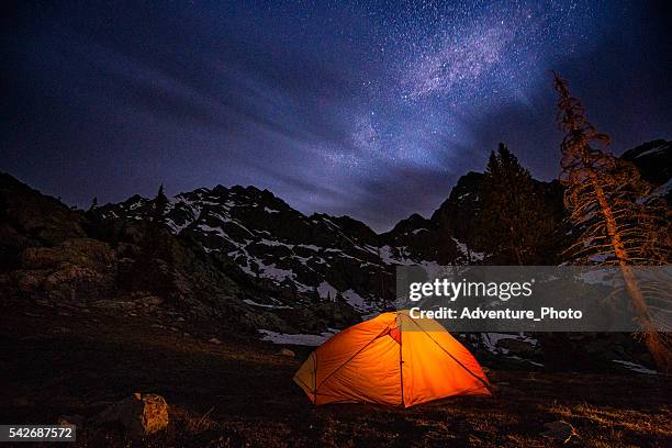 glowing tent backpacking under the stars at night - piney lake stock pictures, royalty-free photos & images