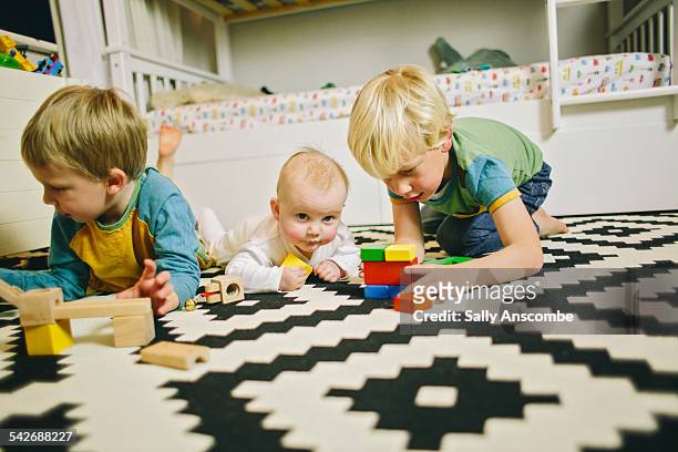 children playing together - siblings baby stock pictures, royalty-free photos & images