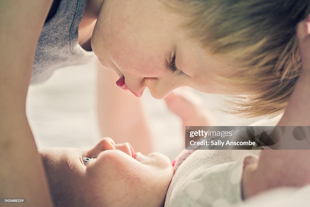 Child giving his baby Sister a kiss