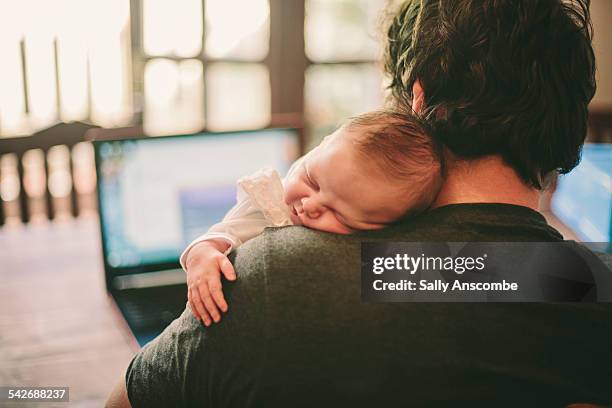 baby asleep on fathers shoulder - dad baby stock-fotos und bilder