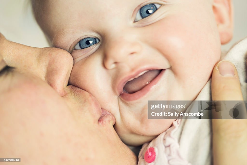 Father kissing his baby on the cheek