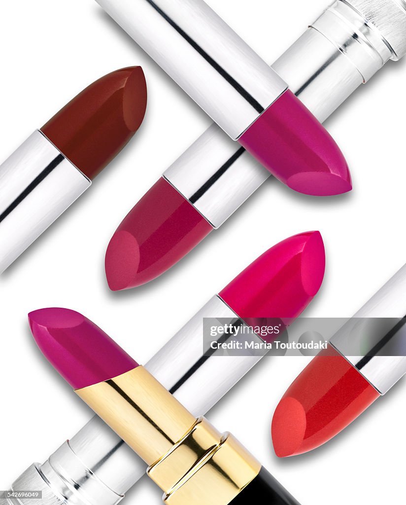 Lipsticks on a heap, on white background