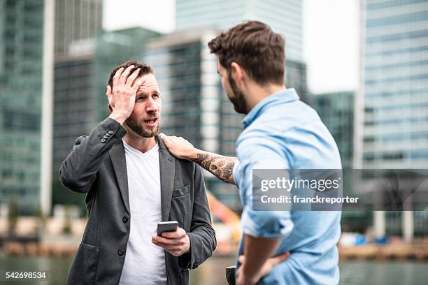 problems in the business - man touching shoulder stockfoto's en -beelden