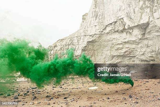 green flare on beach with chalk cliff - colour smoke ストックフォトと画像