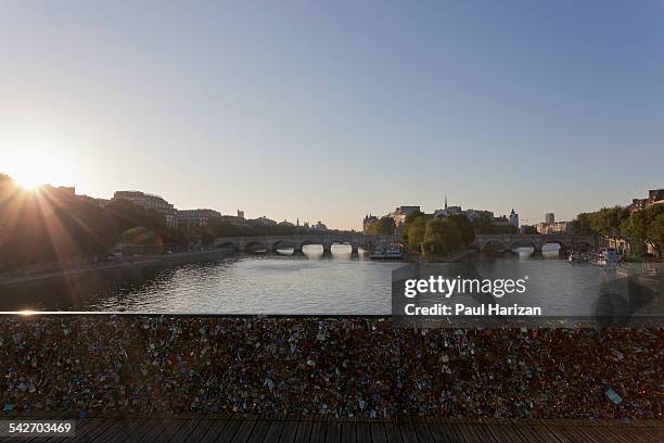 pont des arts with locks in paris at sunrise - pont des arts padlocks stock pictures, royalty-free photos & images