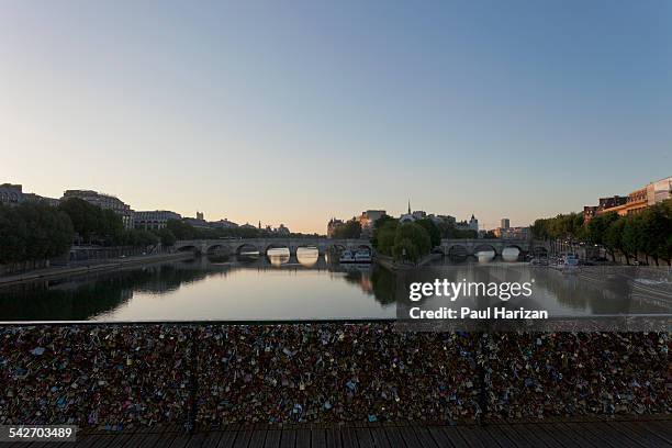 pont des arts with locks in paris at sunrise - pont des arts padlocks stock pictures, royalty-free photos & images