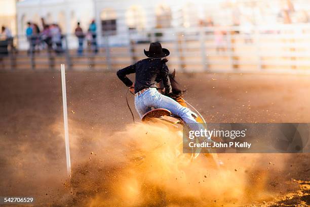 women barrel racing at a rodeo - rodeo stockfoto's en -beelden