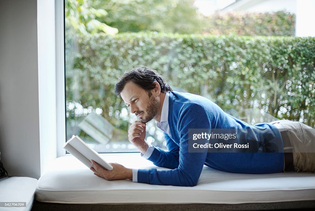 Man using digital tablet at the window