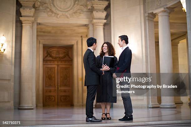 gay couple in city hall with justice of peace - plaatselijk overheidsgebouw stockfoto's en -beelden