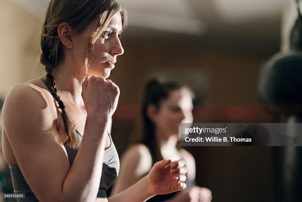Woman Boxer training with punching bag