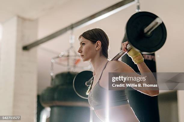 female weight lifting with barbell - weight lifting stock-fotos und bilder